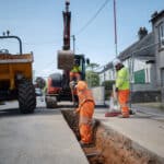 A team of civil engineering workers collaborating on a street project for Glanville Trenchless.